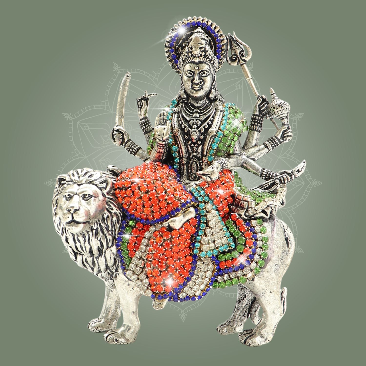 Decorative figurine of a deity on a lion with colorful embellishments on a gray background