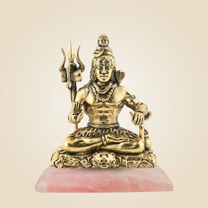 Bronze statue of a seated figure with a trident on a pink stone base