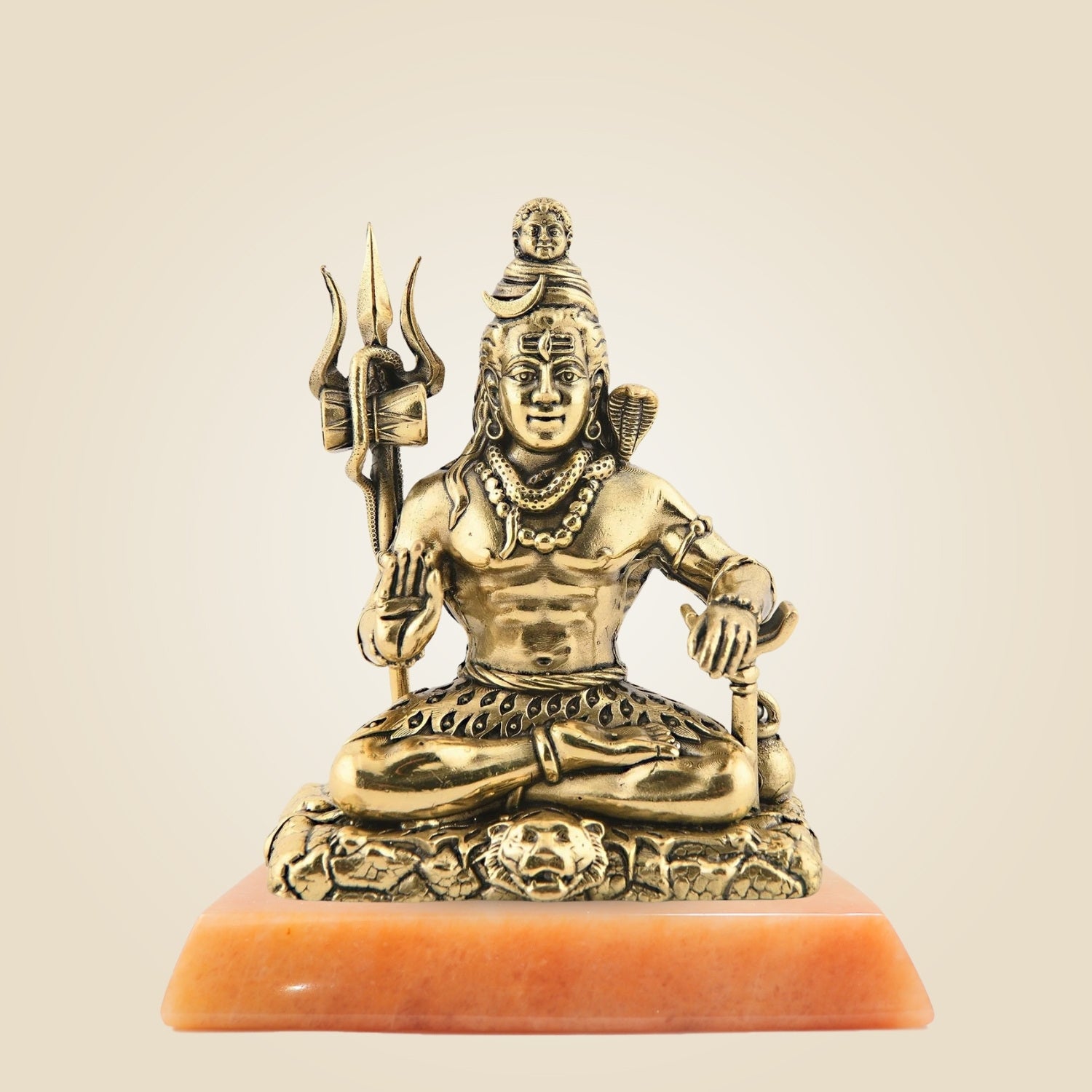Bronze statue of a seated figure with a trident on a beige background