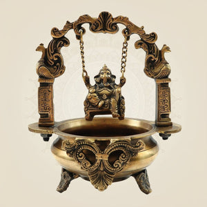 Elegant Brass Ganesh Idol on Jula Swing with Urli